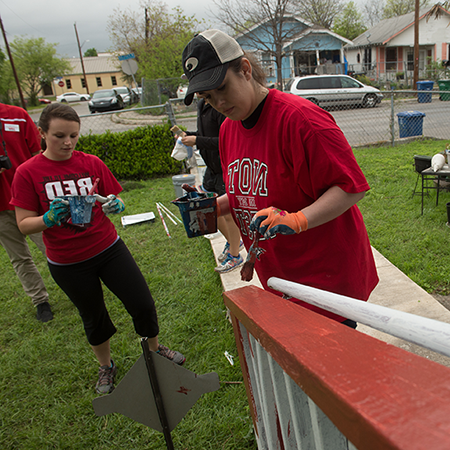 Students volunteering to paint a house